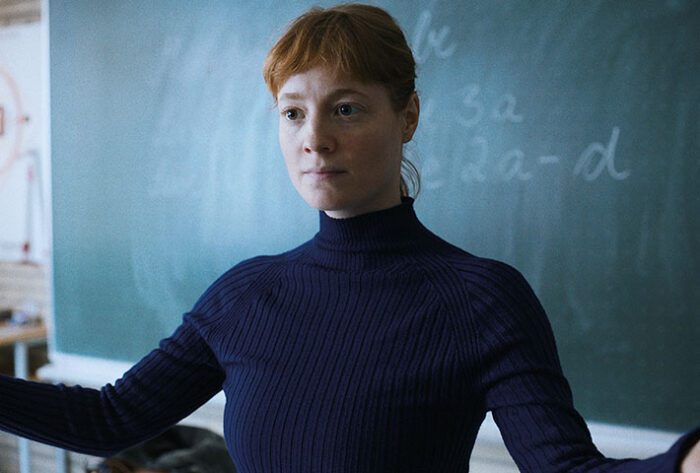 Carla (LEONIE BENESCH) stands in front of her class.