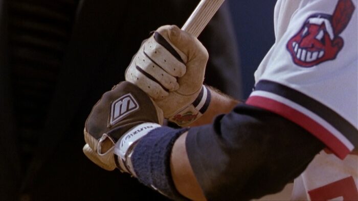 A batter's hands grip his bat tightly. 