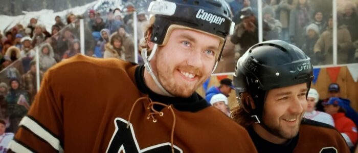Kevin Durand and Russell Crow as "Tree" Lane John Biebe in Mystery, Alaska (1999). Screen capture off Amazon. Hollywood Pictures/Buena Vista Pictures Distribution. Two hockey players in uniform on the ice grinning after brutalizing an opponent.