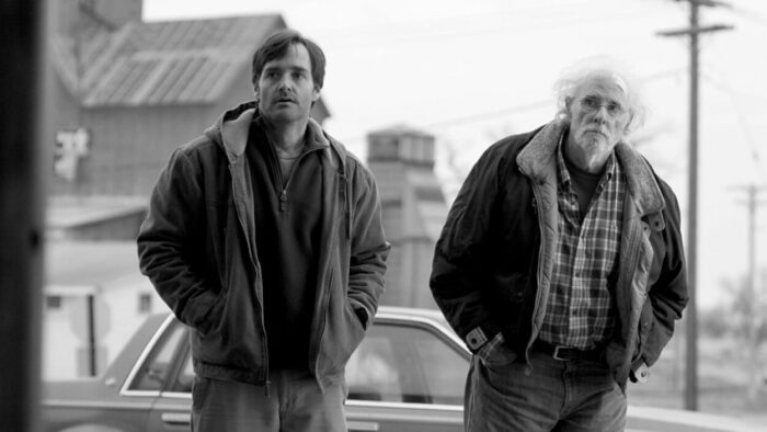 David and Woody Grant (Will Forte and Bruce Dern) stand outside in the Alexander Payne film Nebraska.
