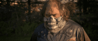 Paugh Shadow as the Omicron Killer in The Omicron Killer (2024). © Dark Knites Entertainment. Glaring man mountain wearing a sinister mask that looks like the lower jaw of a skeleton, teeth and bone all exposed.