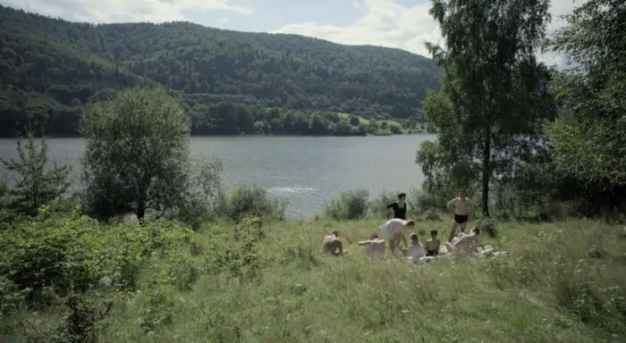 A family picnics by a bucolic river in Auschwitz in The Zone of Interest, which was written and directed by Jonathan Glazer.