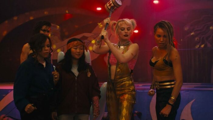 The core, predominantly female, cast of Birds of Prey (and the Fantabulous Emancipation of One Harley Quinn). Margot Robbie as Harley Quinn is in the center, holding up a large mallet.
