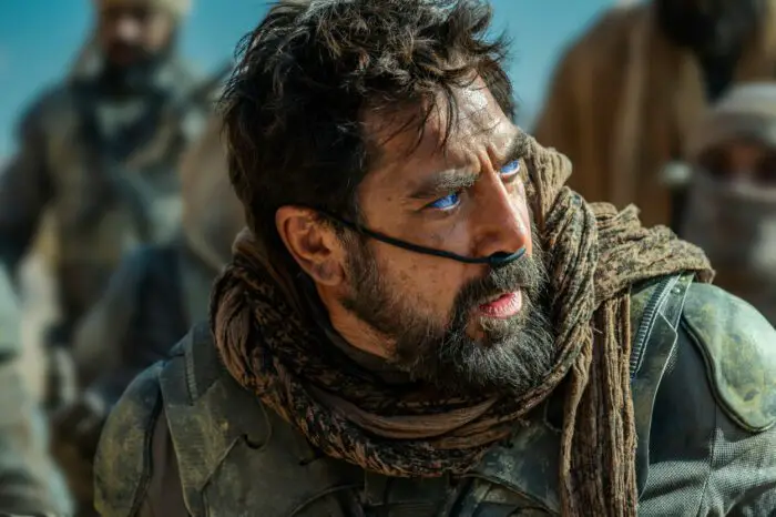 JAVIER BARDEM as Stilgar in Warner Bros. Pictures and Legendary Pictures’ action adventure “DUNE: PART TWO,” a Warner Bros. Pictures release. © 2023 Warner Bros. Entertainment Inc. All Rights Reserved. Photo Credit: Niko Tavernise. Bearded Javier Bardiem in the fictional gear of a Fremen, the desert people of the Dune, a loose black assembly of cloth and tubing that absorbs water and makes desert traversal easier.