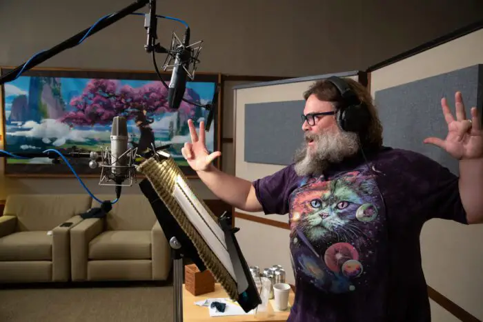 A voice actor is reading lines into a microphone for Kung Fu Panda 4