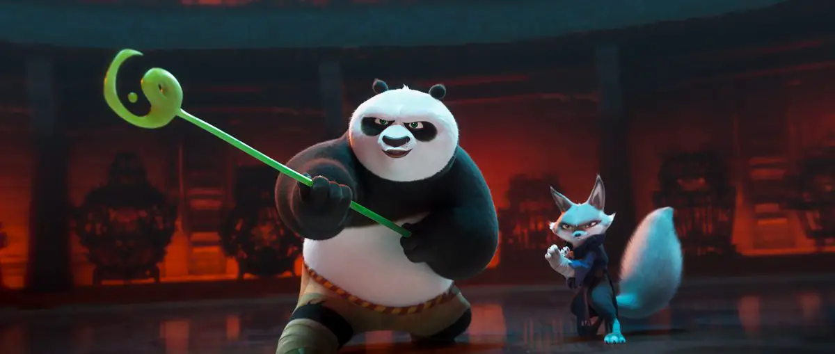A panda with a staff and a fox stand ready to fight in Kung Fu Panda 4