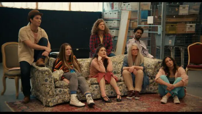 Sam and the cast sit on a couch in First Time Female Director