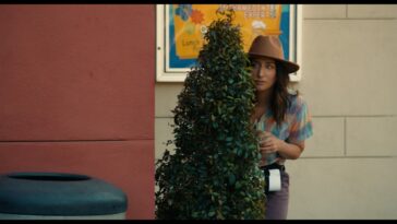 Sam hides behind a plant in First Time Female Director