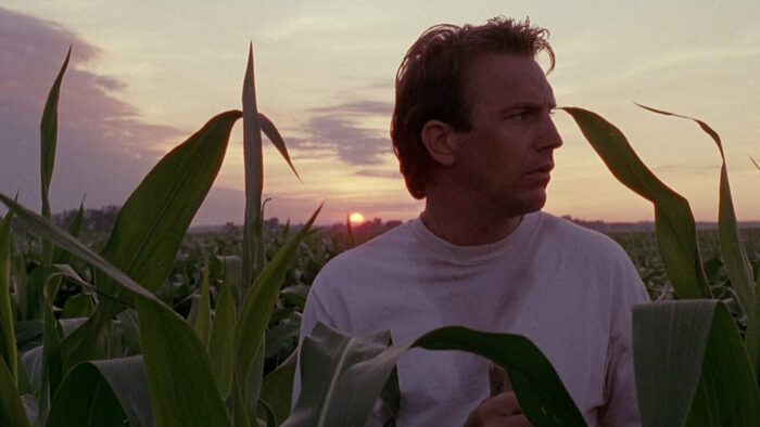 Kevin Costner as Ray Kinsella standing in a corn field in Field of Dreams.