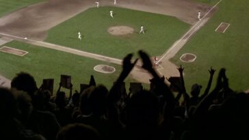 Image from Major League depicting a large group of fans in their seats during a baseball game.