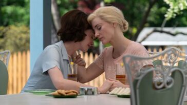 Alice (Jessica Chastain) , right, lightly embraces Celine (Anne Hathaway) during an outdoor lunch.