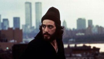 Serpico looks behind him with New York City in the background.