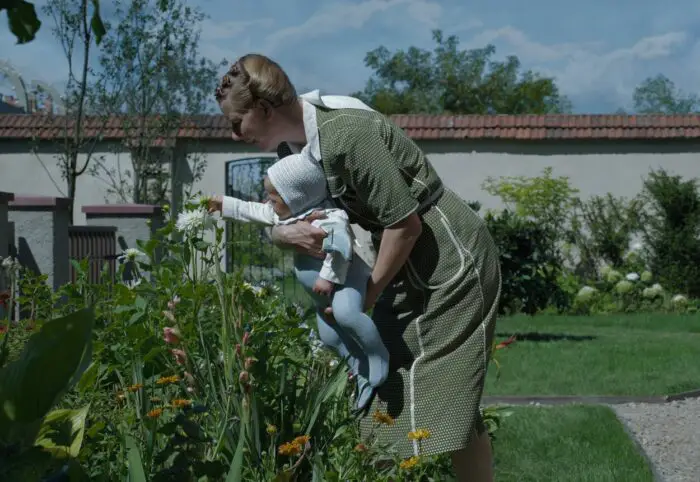 Hedwig Höss (Sandra Hüller) admires her garden with her infant child.
