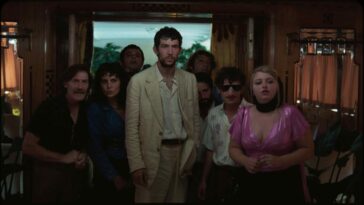 A bedraggled Arthur (Josh O'Connor) stands amidst a motley crew in a rustic tavern in La Chimera.