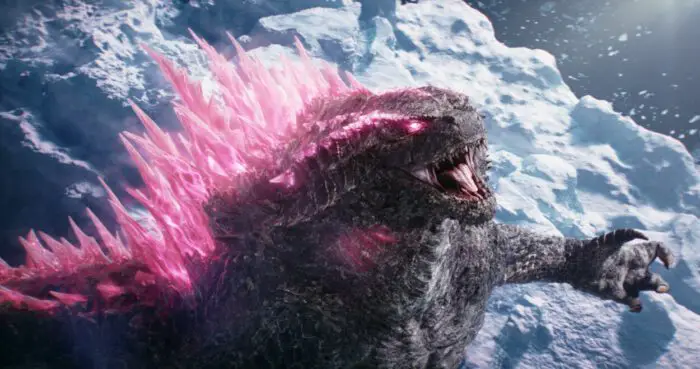 Godzilla screams at the sky in the Arctic Ocean with his spikes glowing pink.