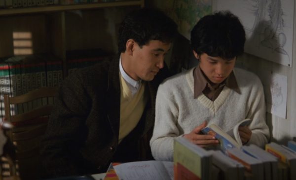 Tutor and student sitting side by side from film The Family Game