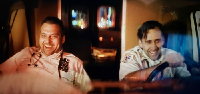 Tom Sizemore and Nicolas Cage as Frank Pierce and Tom Wolls in BRINGING OUT THE DEAD (1999). Screen capture off of Amazon. Paramount Pictures. Paramedics in Frank and Tom giggle like giddy children while driving erratically through the city streets.