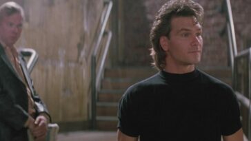 A club owner stands behind a cooler talking to his staff in Road House