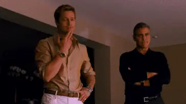 Two men talk to another in a hotel room in Ocean's Thirteen, part of the Ocean's trilogy.
