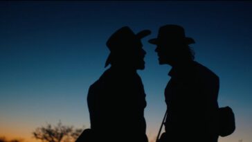 Two Civil War soldiers facing each other, silhouetted against a blue sky.