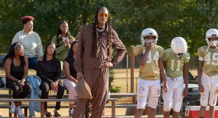 Tika Sumpter as Cherise and Snoop Dogg as Jaycen "Two Js" Jenning star in director Charles Stone III's The Underdoggs, standing on the sidelines in this scene.