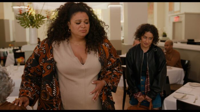 Michelle Buteau and Ilana Glazer as Dawn and Eden in BABES. Photo Credit to Gwen Capistran. Photo Courtesy of NEON. Dawn and Eden hurrying to leave a restaurant as Dawn comedically goes into labor.