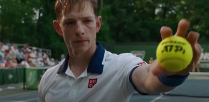 Art (Mike Faist) shows a ball to the camera.