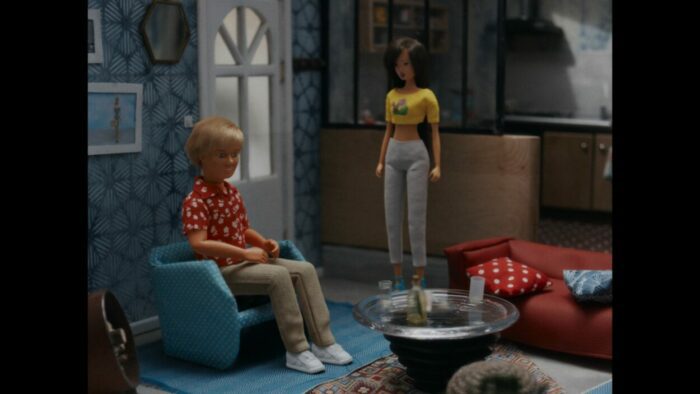 A male and female doll in a diorama.