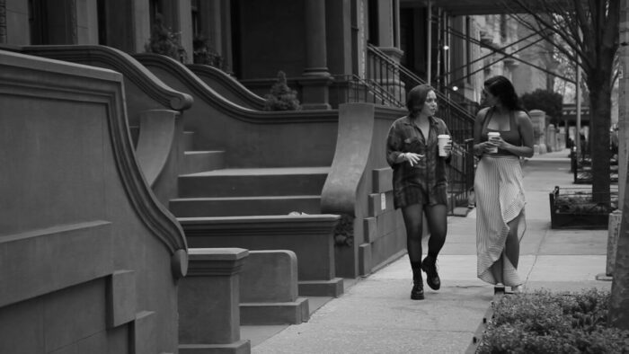 Two women walk down a New York City street.