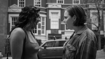 Two women talk on a street in Guy Friends.