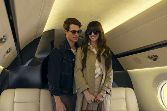 A man escorts a woman onto a private jet in The Idea of You.