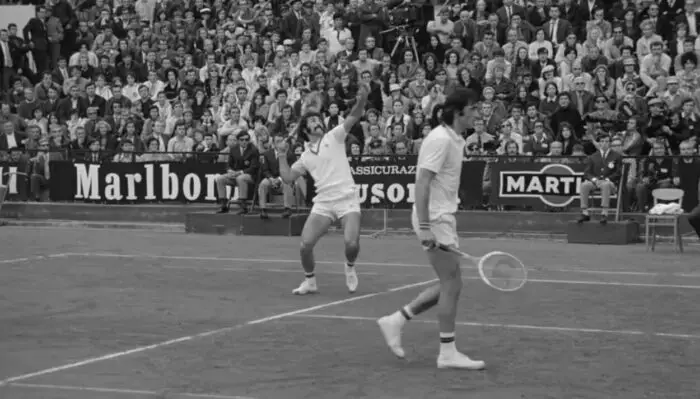Ion Tiriac (left) readies an overhead as partner Ilie Nastase watches in the 1972 Davis Cup Final.