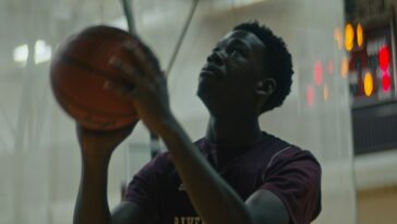 A basketball player readies a shot in practice.