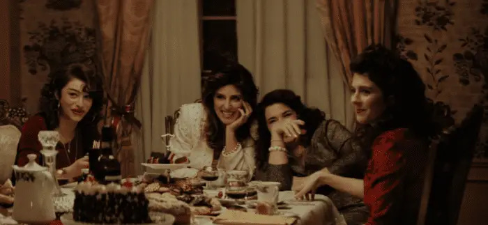 [L-R] Odessa A’zion, Jennifer Esposito, Annabella Sciorra, and Emily Bader as Connie, Francine, Christine, and Rose in Fresh Kills (2023). Courtesy of Quiver Distribution. Italian ladies sitting around a fancy Christmas dinner laughing and enjoying themselves.