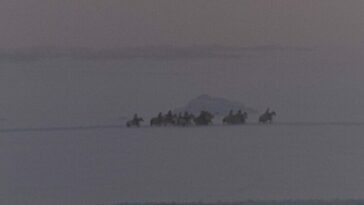 A still from The Savage Hunt of KIng Stakh depicting riders across a snowy pasture.