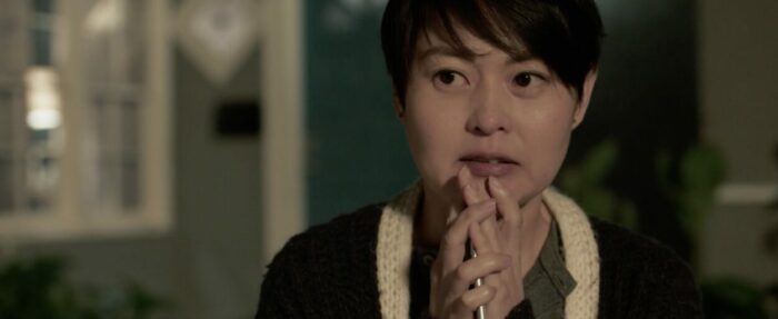 Simone (Sam Yim) looks concerned.