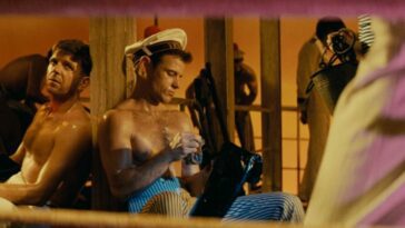 A shirtless Querelle (Brad Davis) on deck of Le Venguer.