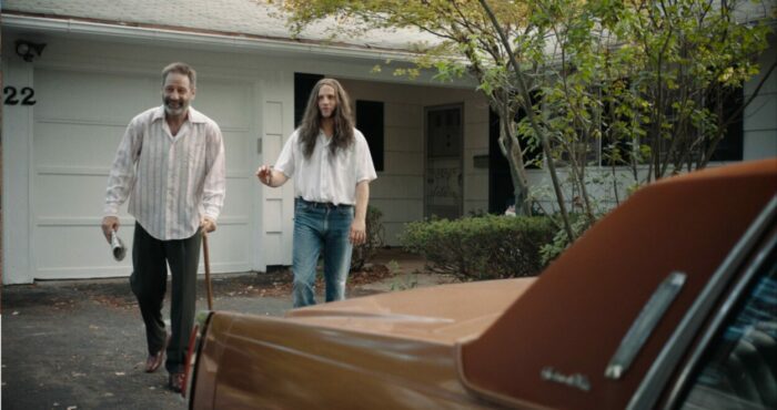 David Duchovny and Logan Marshall-Green as Marty and Ted in Reverse the Curse (2023). Courtesy of Vertical and R&CPMK. Estranged father and son Marty and Ted head down the driveway to take off on a road trip.