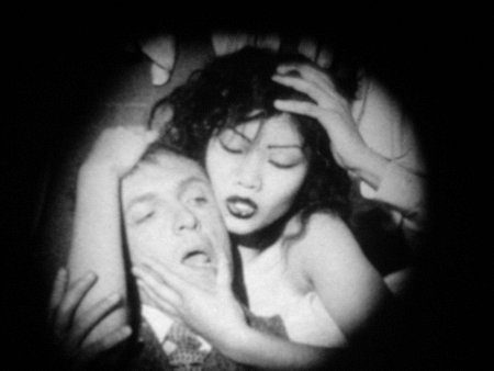 A man and woman embrace and clutch each other's heads in Guy Maddin's Cowards Bend the Knee