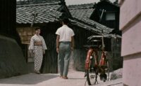 Kayo (Ayako Wakao) greets Kiyoshi (Hiroshi Kawaguchi)) in Floating Weeds (1959).