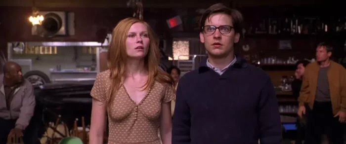 Mary Jane Watson and Peter Parker standing in a coffee shop amid carnage