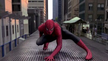 Spider-Man crouched on a train
