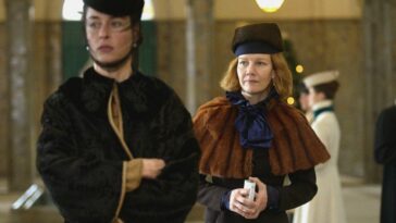 Countess Irma (Sandra Huller) follows behinds Empress Sisi (Susanne Wolff) as she walks.
