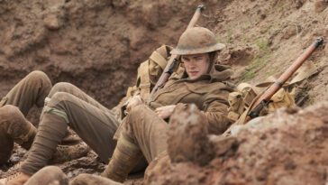 A soldier reclines in a muddy trench in Before Dawn