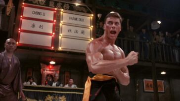 A man flexes and screams at his opponent on the mat in Bloodsport.