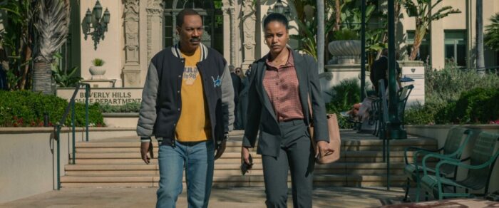 A man and his daughter walk down municipal steps outside in Beverly Hills Cop: Axel F.