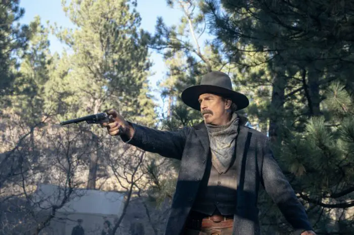 A man with a moustache holds a revolver ready to fire in Horizon: An American Saga.