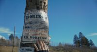 A flyer advertising new land out west is nailed to a pole in Horizon: An American Saga