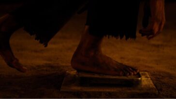 Close-up shot of a foot standing on a fumi-e.